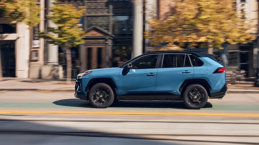 Blue Toyota RAV4 Driving on the City Street