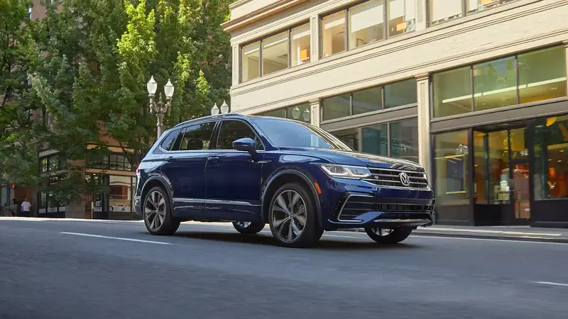 Photo of a 2024 Volkswagen Tiguan traveling on an urban street during the daytime.