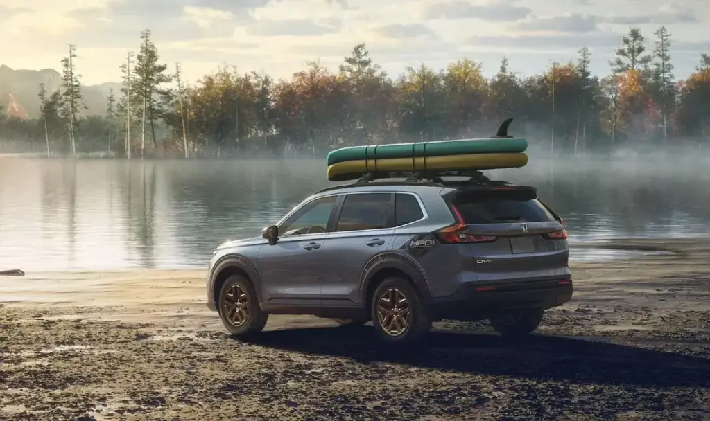 Urban Gray Pearl CR-V parked on the Side of a lake with a Kayak on top of it