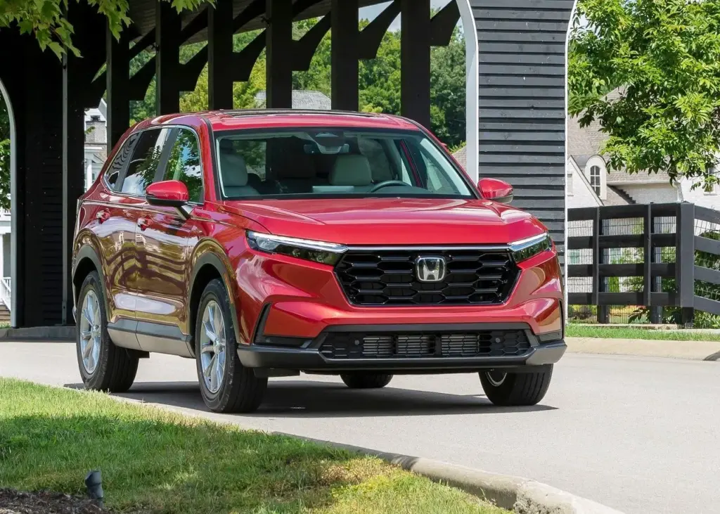 Radiant Red Metallic Honda CR-V Drive on the Park During Daylight